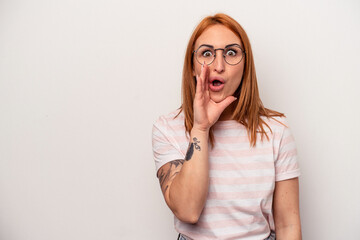 Young caucasian woman isolated on white background is saying a secret hot braking news and looking aside