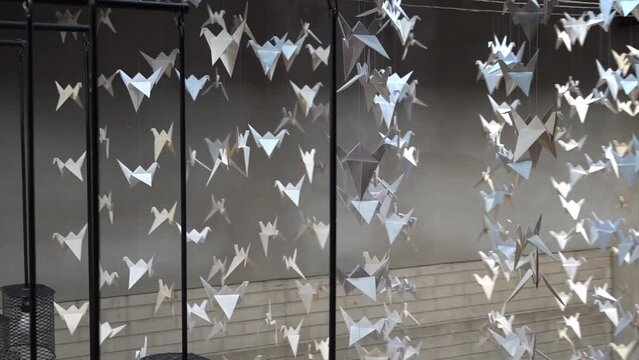 Paper cranes made with origami hanging from the ceiling