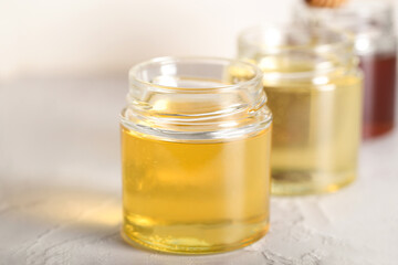 honey of different varieties is on the table in glass jars