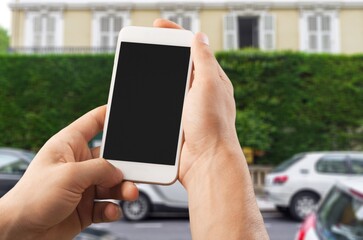 Business and financial concept. Hand with smartphone with a blank screen