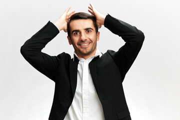 manager in a modern suit holding his head with a smile emotion self-confidence official business...
