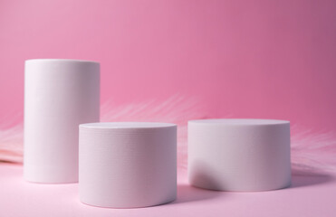 Minimal layout with a podium for product demonstration. Abstract white background of geometric shape on a minimalistic pink background.