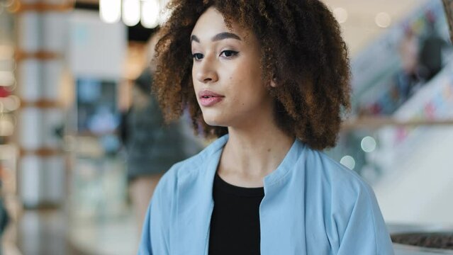 Portrait african american girl looking at wrist watch waiting date with boyfriend business meeting looking around worries woman with curly hair checks time sad due late drink coffee tea from paper cup