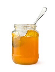 fruit jam bottle with a spoon, isolated on white background, closeup