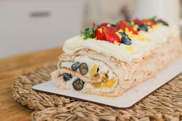 berry roll decorated with raspberry strawberries and blackberries in a section. Close-up