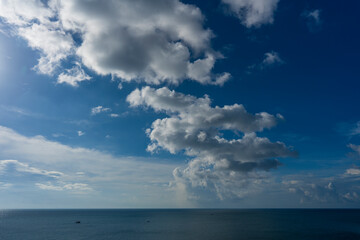 Naklejka na ściany i meble Natural daylight and white clouds floating on blue sky at sunny day over the sea