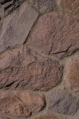 Pattern of ancient bricks and stones at old middle age wall, as a background, closeup, details.
