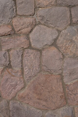 Pattern of ancient bricks and stones at old middle age wall, as a background, closeup, details.