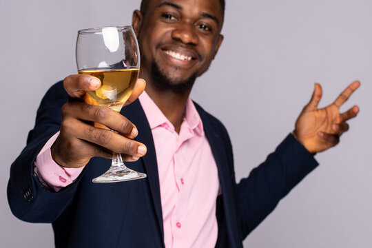 Excited Young Black Man Raises A Glass Of Wine