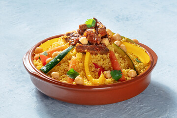 Meat and vegetable couscous in a bowl, typical food from Morocco, a traditional festive Arabic dish with herbs and spices - obrazy, fototapety, plakaty