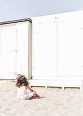 Little girl sitting on the beach