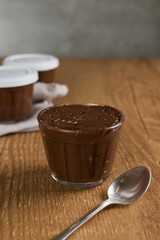 Brazillian chocolate sweet called Brigadeiro in pot on wooden desk background. Vegan version