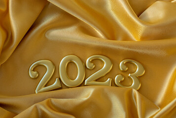 happy new year 2023 new year holidays postcard gold color numbers on the background fabric silk