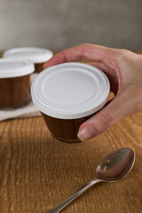Brazillian chocolate sweet called Brigadeiro in pot on wooden desk background. Vegan version
