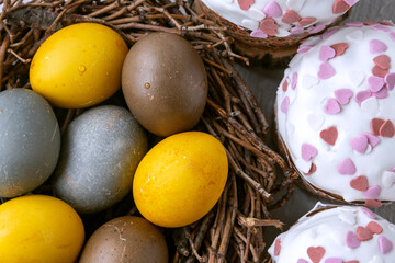 Delicious Easter cakes and dyed eggs top view. Happy Easter. Close up