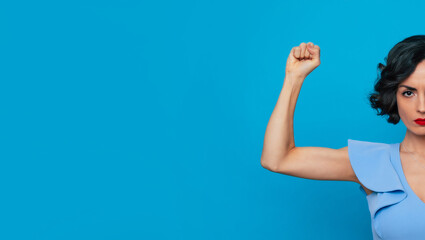Women's rights. Feminism. Equality of gender. Powerful serious strong conceptual woman feminist shows her biceps and fist. International womens day - obrazy, fototapety, plakaty