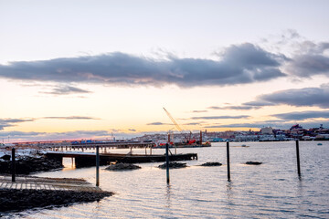 An old ruined pier in the bay and a view of the evening city. Portland. USA. Maine.
