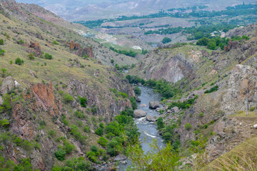 Fototapeta na wymiar beautiful river runs between the rocky mountains
