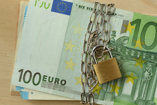 Closeup of euro banknote locked with chain and padlock - Stop cash concept