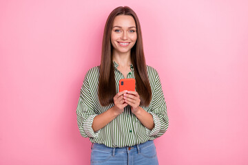 Photo of confident cheerful lady dressed green shirt communicating modern gadget isolated pink color background