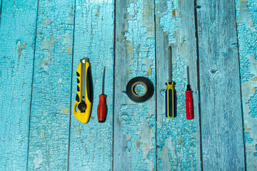 hand tools on wood background,screwdriver,knife,measuring tool