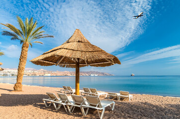 Morning on central beach of the Red Sea in Eilat - famous tourist resort and recreational city in Israel