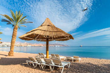Fototapeta na wymiar Morning on central beach of the Red Sea in Eilat - famous tourist resort and recreational city in Israel
