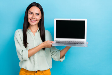 Photo of young pretty woman demonstrate laptop recommend select proposition isolated over blue color background