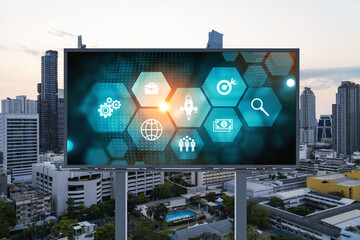 Hologram of Research and Development glowing icons on billboard. Sunset panoramic city view of...
