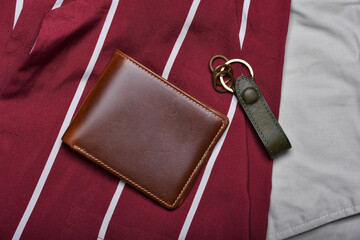 Genuine leather wallet, Handcraft full grain brown bifold wallet on shirt background, Men fashion and accessory.