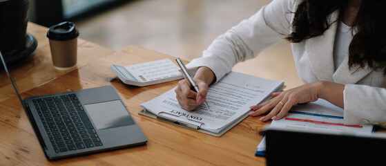 Salesmen are letting the female customers sign the sales contract, Asian woman doing business in the office, Business concept and contract signing.