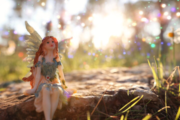 image of magical little fairy in the forest at sunset