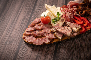 Traditional Romanian food. Close up view of a food plate made of pork meat against a wooden background.