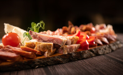 Traditional Romanian food. Close up view of a food plate made of pork meat against a wooden background.