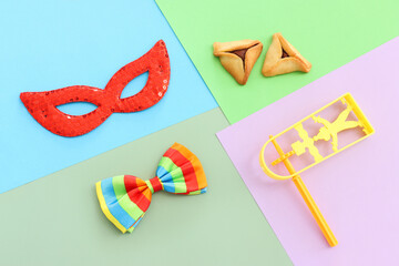 Purim celebration concept (jewish carnival holiday) over colorful background