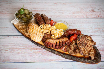 Traditional Romanian food. Close up view of a food plate made of pork meat against a wooden background.