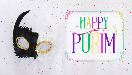 Purim celebration concept (jewish carnival holiday) over white sparkle chiffon background
