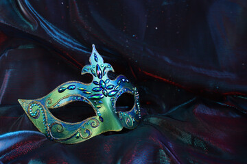 Photo of elegant and delicate Venetian mask over dark background