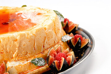 Pudding dessert with caramel sauce accompanied by red berries, Caramel pudding, Neapolitan flan on a white background, close up