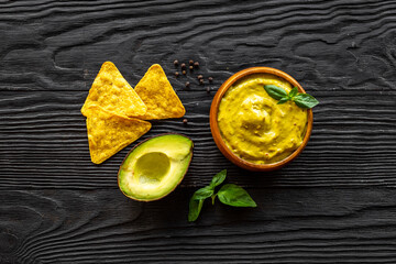 Green guacamole avocado dip in bowl, top view