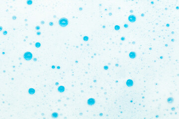 Soap foam, bubbles on a blue background. Hygiene and home cleaning.