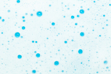 Soap foam, bubbles on a blue background. Hygiene and home cleaning.