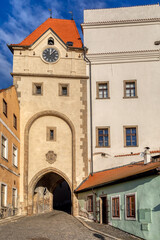 Obraz premium Old town view of narrow aisle with city gate in Jindrichuv Hradec, a town in the Czech Republic in the region South Bohemia. The old town view.
