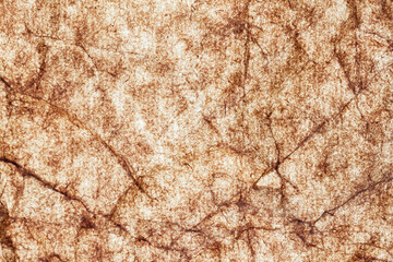 Fototapeta premium Wrinkled porous brown paper close-up. Background, texture