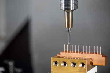 Closeup scene the CNC milling machine cutting the  copper electrode parts with solid ball end mill...