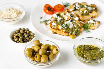 Olives, chimichurri sauce. Vegetarian food. White background.