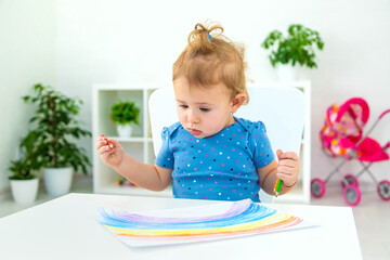 The child draws a rainbow. Selective focus.