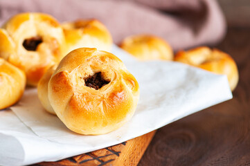 Middle Asian authentic baked meat hand pies  - belyash or samsa served on wooden background. Close...
