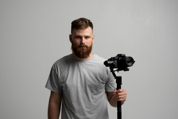 Professional videographer filmmaker cinematographer dop using dslr camera on gimbal stabilizer isolated on white background. Directop of photography, cameraman.