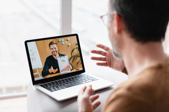 Caucasian businessman boss CEO freelancer e-learning having videocall conference conversation meeting online on laptop with colleague teacher tutor showing charts remotely on distance watching webinar